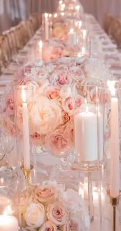 a long table with candles and flowers on it