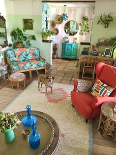 a living room filled with furniture and lots of plants on top of the tables in front of them