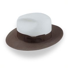 Description Materials Craftsmanship Hat Care Shipping Returns Product Description Elegant Two-Tone Panama Fedora: Where Straw Meets Felt Introducing the Monarch, a unique two-tone Panama fedora that blends the best of both worlds. This distinctive hat features a breathable Toquilla straw crown in off-white, beautifully contrasted with a taupe brown rabbit fur felt brim. The Monarch boasts a classic center-dent crown standing 5" tall and a generous 3" raw-edge snap brim, creating a silhouette tha Homburg Hat, Hats For Big Heads, Homburg, The Monarch, Jazz Age, Crown Design, Formal Casual, Head Shapes, Hat Band