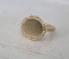 Gold disc ring, gold round ring, gold statement ring, gold cocktail ring, round disc ring, organic design ring, disc ring, matte gold ring Handmade hammered gold disc, decorated with tiny gold bits of metal (granulates) and soldered to a gold plated band. The ring was made in an organic design and is deliberately imperfect beautiful gold cocktail ring. Dimensions: The disc diameter is 0.5 inch The band is available in multiple sizes. if you need a different size just let me know. The gold disc r Gold Plated Dome Ring Promise Ring, Gold Plated Round Dome Promise Ring, Gold Plated Dome Promise Ring, Handmade Gold Plated Midi Rings, Handmade Yellow Gold Midi Rings, Gold Plated Dome Ring For Wedding, Wedding Gold Plated Dome Ring, Gold Round Halo Ring For Promise, Minimalist Gold Cluster Ring