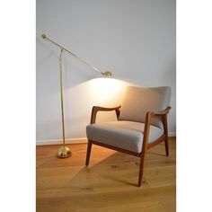 a chair with a lamp next to it on a hard wood floor