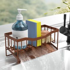 a soap dispenser, soap dish and sponge holder on a window sill