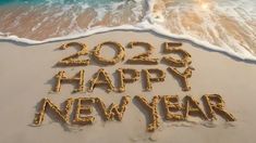 the words happy new year written in sand at the beach