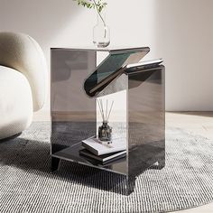 a glass table with some books and a vase on it