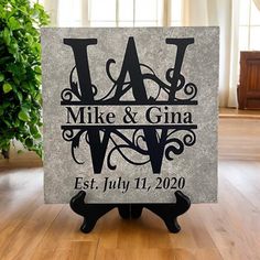 personalized slate block with monogrammed initials and date on it in front of a potted plant