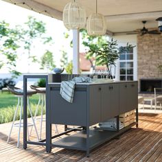 an outdoor kitchen is set up on the deck