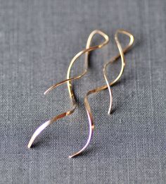 "Gorgeous new earrings made using Sterling silver and 14K gold filled. These are wire threader style earrings, and have a unique design. They have an amazing swirl design, with a shorter swirl in the front, and a wider, longer swirl in the back. Earrings will hang 2\" in the back, and 1 1/4\" in the front. Each is hand forged. Listing is for one pair in metal of choice. Please choose desired metal finish at checkout. ** Nickel and lead free" Gold Wrap Earrings With A Modern Twist, Modern Twist Wrap Earrings As A Gift, Modern Twist Wrap Earrings For Gift, Gold Minimalist Spiral Wrap Earrings, Minimalist Gold Spiral Wrap Earrings, Gold Spiral Minimalist Earrings, Minimalist Gold Spiral Earrings, Metal Minimalist, Minimalist Lighting