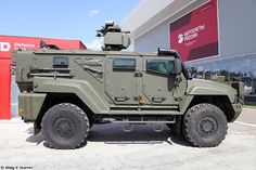 an army vehicle parked in front of a building