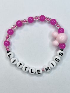 Be all the trend with this Little Miss bracelet. Beaded and stretchy with vibrant pink glass ball beads and a large mouse ears charm, everyone will know your Little Miss theme park obsessed! Bracelets are available in a variety of lengths.  Pick your custom length from the drop down menu below.  All our bracelets are made with quality in mind.  With that being said, all bracelets should be treated with care while putting on, wearing, and taking off.  Keep dry. Do not swim or bath with them. Little Miss Bracelets, Mickey Bead Bracelet, Pink Novelty Beaded Bracelets, Disney Beaded Bracelet, Theme Park Fashion, Beaded Mickey Mouse Bracelet, Costume Bracelets, Park Day, Trend Jewelry