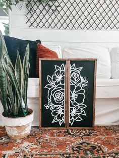 a potted plant sitting on top of a rug next to a wooden frame