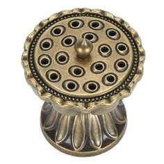 an old fashioned metal knob with holes on it