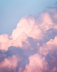 the plane is flying high in the sky with clouds behind it and an airplane on the far side