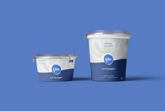 two buckets of yogurt on a blue background