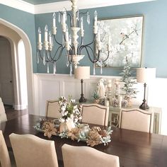 a dining room table with chairs and a chandelier