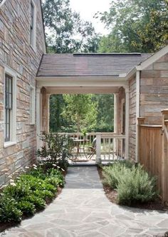 a stone walkway leading to a wooden building