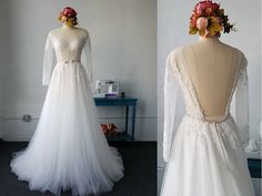 the back of a wedding dress with sheer sleeves and flowers on it's head