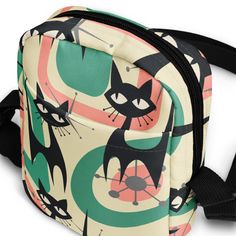 Carry all your essentials in retro style with the Atomic Cat Sling Bag! This 60s Mid Mod Crossbody bag in Teal, Coral, and Green is the perfect funky and fun addition to your everyday wardrobe. Vintage never goes out of style! This bag is sturdy, stylish, and ready to go wherever you do. With adjustable straps and two spacious pockets, it’s the ultimate accessory for hiking, festivals, and everyday use.• 100% polyester• Fabric weight: 9 oz./yd.² (305 g/m²)• Bag size: 5.7″ × 7.7″ × 2″ (14.5 cm × 19.5 cm × 5 cm)• Capacity: 0.37 gallons (1.4 l)• Water-resistant and durable• Sturdy fabric with fusible backing to add firmness• Inside and outside pockets• Adjustable strap• Two-way zipperThis product is made especially for you as soon as you place an order, which is why it takes us a bit longer t Green Retro Crossbody Shoulder Bag, Retro Green Crossbody Shoulder Bag, Retro Green Bags, Retro Multicolor Shoulder Bag, Retro Crossbody Shoulder Bag, Retro Flap Shoulder Bag, Retro Crochet Shoulder Bag, Retro Shoulder Bag For Everyday Use, Retro Everyday Shoulder Bag