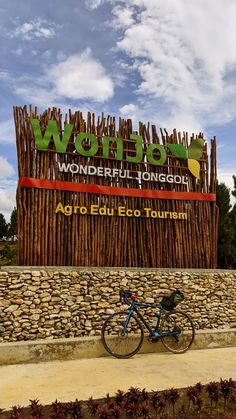 a bike is parked in front of a sign