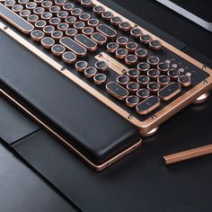 a black and gold keyboard sitting on top of a desk