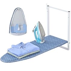 an ironing board, shirt and iron on top of it with clothes next to it