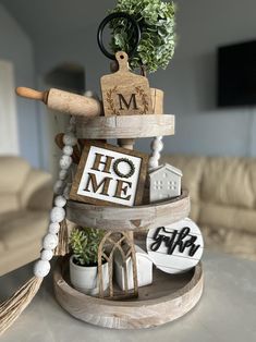 a wooden stand holding various items on it's sides and the word home spelled out