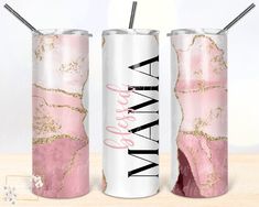 two pink and gold water bottles with straws in them