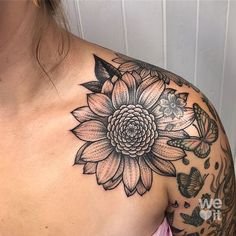 a woman with a flower tattoo on her shoulder