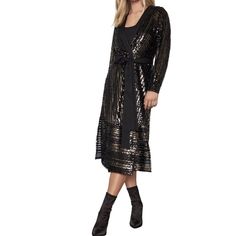 This sequin wrap dress features a mix of gold and black sequins with long sleeves, and finished with a sash tie at the waist and a slip.Snap button closure at center front; Snap buttons at slip lining100% polyester sequin; Lining: 100% polyester tulle (under self); 100% polyester crepe de chine (slip lining)Hand wash Contrast Sequin Dress For Fall, Gold Sequin Evening Dress For Fall, Belted Wrap Dress For Party, Party Wrap Dress With Tie Waist, Festive Fall Sequin Dress With Contrast Sequins, Fall Festive Sequin Dress With Contrast Sequin, Fall Sequin Dress For Date Night, Festive Fall Contrast Sequin Dress, Tie Waist Dresses For Night Out In Fall