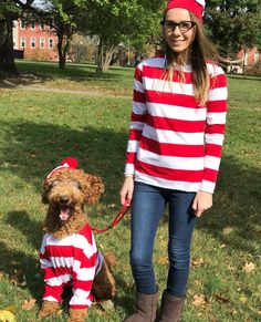 a woman in a red and white striped shirt standing next to a dog