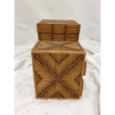 a wooden box with an intricate design on the front and sides, sitting on a white background