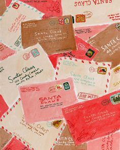 many different colored envelopes are scattered on the table top with red and pink ink