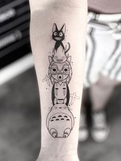 a person with a cat tattoo on their leg