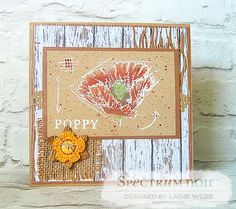 a close up of a card on a wooden surface with a flower in the middle