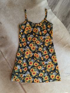 "Elevate your vintage wardrobe with this 90s Cotton Cami Slipdress from Rampage. Featuring a sunflower print, this dress is a perfect addition to your summer wardrobe.  The delicate cami straps add a touch of femininity while the slinky silhouette and lightweight fabric make it comfortable to wear all summer long. Does not have much stretch, so please check measurements! Made in the USA. This sundress is a true gem and a must-have for any vintage lover 🌻 100% Cotton Measurements taken flat PTP Summer Mini Dress With Daisy Print, Summer Daisy Print Mini Dress, Yellow Sundress With Sunflower Print For Summer, Casual Yellow Sunflower Print Dress, Vintage Printed Summer Mini Dress, Yellow Sleeveless Sundress With Sunflower Print, Fitted Daisy Print Mini Dress For Beach, Sleeveless Sundress With Sunflower Print For Spring, Casual Fitted Sunflower Print Dress