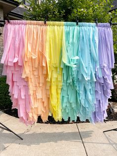 there are many different colored ribbons hanging on the clothes line