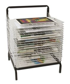 a stack of magazines sitting on top of a metal rack