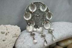 This is the perfect option for those who like cool, unique jewelry, and the luxury, shine of sterling. Vintage Norwegian J 830 Silver Pin Brooch. Composed of filigree circle and 7 cascade of silver filigree with spoons which manages to catch & reflect light beautifully (also reflect negativity & evil) with a simple movement. Is Norway's traditional silver jewelry. Its dangling spoons once were thought to reflect evil. Away from the wearer, protecting one from trolls and other dangers, es Silver Bohemian Brooch Jewelry, Silver Bohemian Jewelry Brooch, Handmade Silver Pendant Brooch, Handmade Silver Pendant Brooches, Unique Silver Pendant Brooch, Ornate Handmade Pendant Brooches, Handmade Ornate Sterling Silver Brooches, Traditional Handmade Sterling Silver Brooches, Handmade Silver Bohemian Brooch