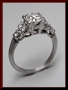 three stone diamond ring on grey background