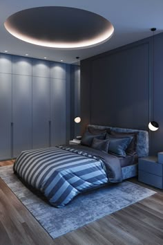 a large bed in a bedroom under a circular light