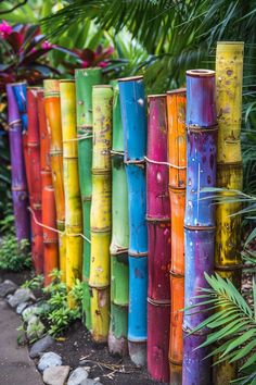 there are many different colored bamboo poles in the garden