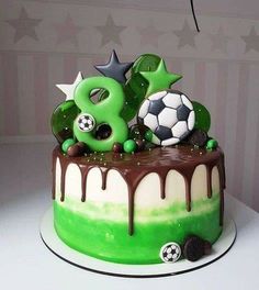 a soccer themed birthday cake with chocolate icing and green frosting on the top