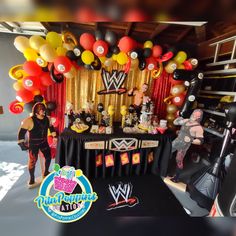 an image of a wrestling birthday party with balloons and decorations on the wall, including wrestler figures