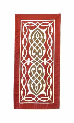 a red and white wall hanging with an intricate design on it's side,