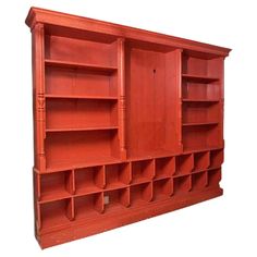 a red bookcase with many shelves on it