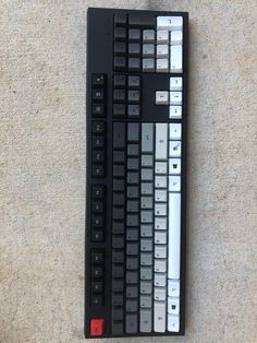 a computer keyboard sitting on top of a carpet