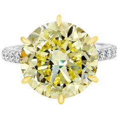 An elegant and extremely well-crafted engagement ring, showcasing a vibrant 10.02 carats round brilliant cut diamond certified by GIA as Fancy Intense Yellow color and VS1 clarity, set on a classic six prong 18K yellow gold basket encrusted with 51 yellow diamonds on the bridge weighing 0.58 carat. Accented by 28 round brilliant cut diamonds weighing 0.55 carat total, pavé set on the shank in a half-way design. Made with a platinum mounting. Size 6 US, resizable upon request. Roman Malakov is a Canary Diamond, Yellow Diamonds Engagement, Yellow Diamond Engagement Ring, Diamond Rings With Price, Contemporary Engagement Rings, Engagement Ring Prices, Yellow Diamond Rings, Engagement Ring Diamond Cut, Round Cut Engagement Rings