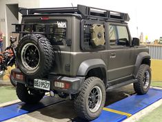 an suv is parked on a ramp in the parking lot