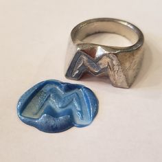 This signet ring is cast in lead-free pewter. The ring size when cast is 7.5. The sealing image is a person in the shape of the letter M.       This is part of a series of signet rings I am making cast from lead-free pewter. Each master ring is hand sculpted to give a unique, rustic style, multi-dimensional relief image when used as a stamp to seal, with sealing wax. Jewelry Font, Yoga Gymnastics, Silver Jewellry, Pewter Ring, Stone Molds, Letter Ring, Signet Rings, Multi Dimensional, Sealing Wax