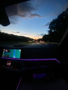 the dashboard of a car with lights on at night