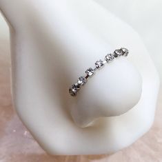 a close up of a ring on a white mannequin